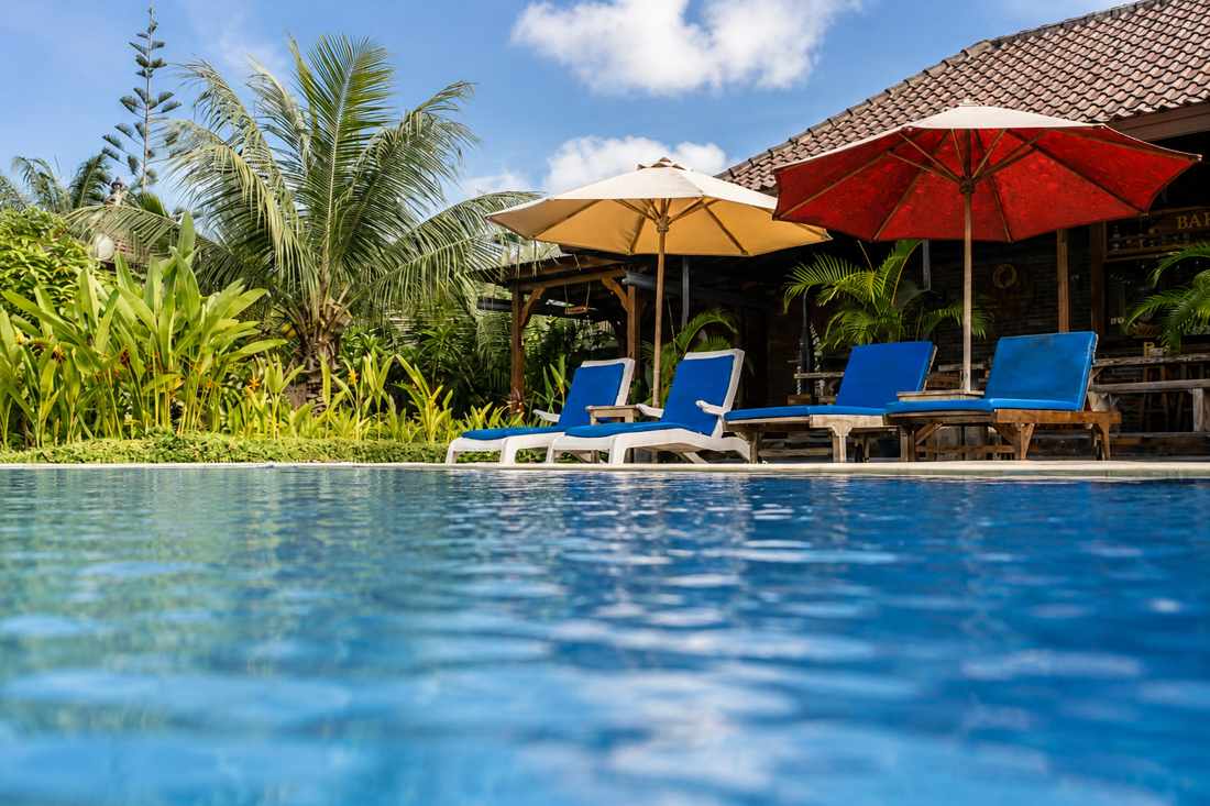 Outdoor pool with loungers and umbrellas